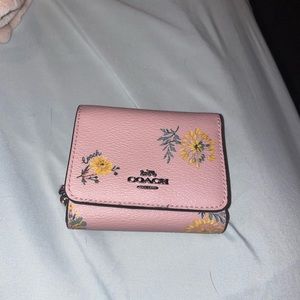 Coach Pink floral wallet with a small pen stain